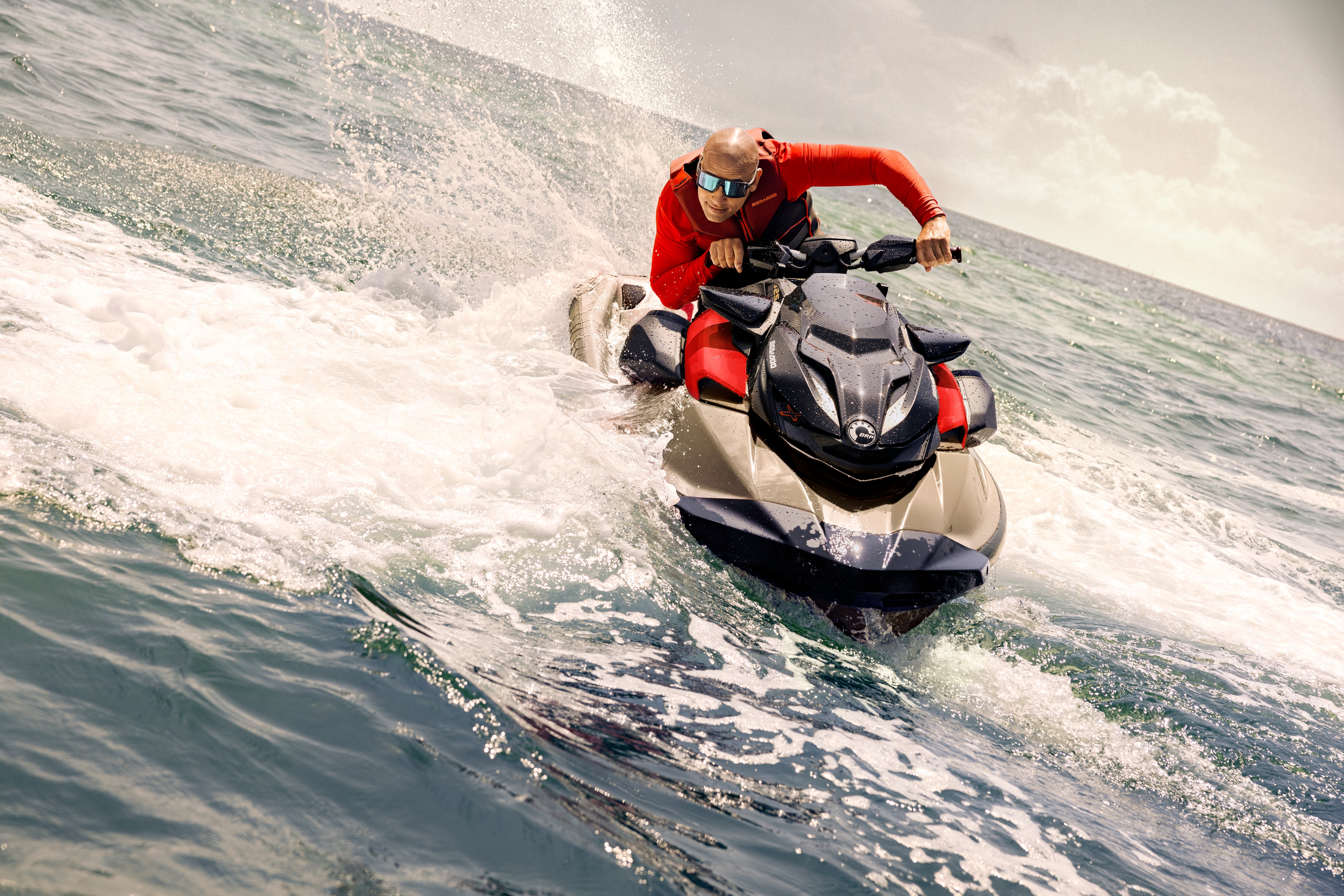 Man sitting on an idle Sea-Doo RXP-X RS personal watercraft