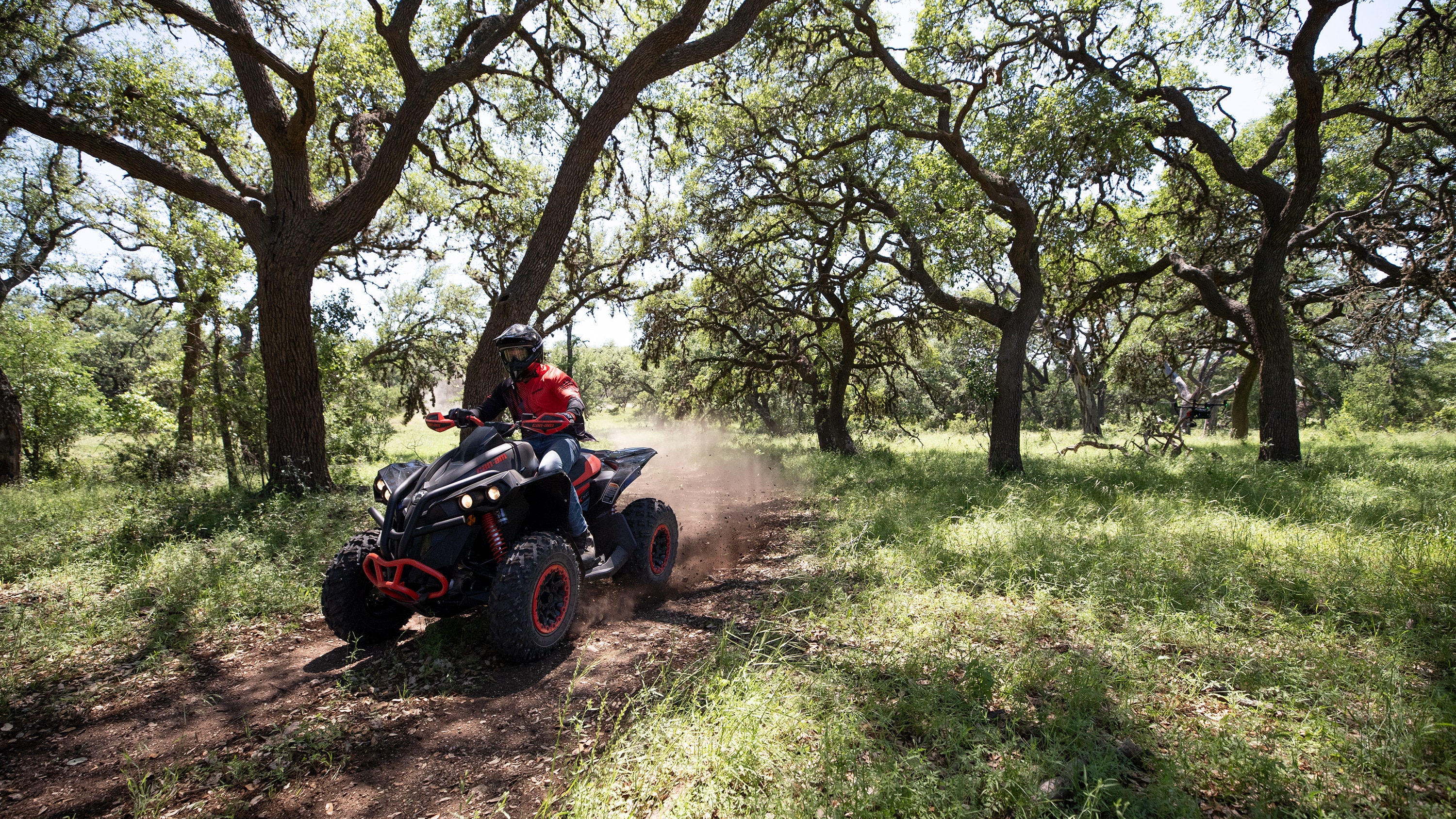 Man driving a Can-Am Renegade 2021 in woodlands