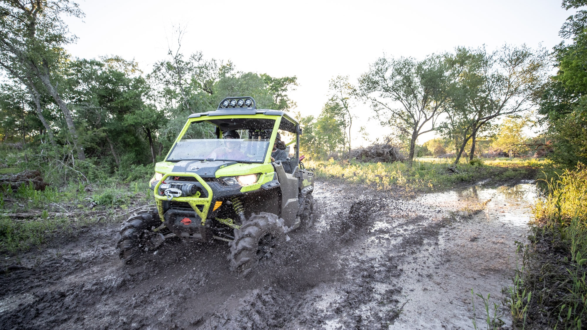 Men driving Traxter through mud