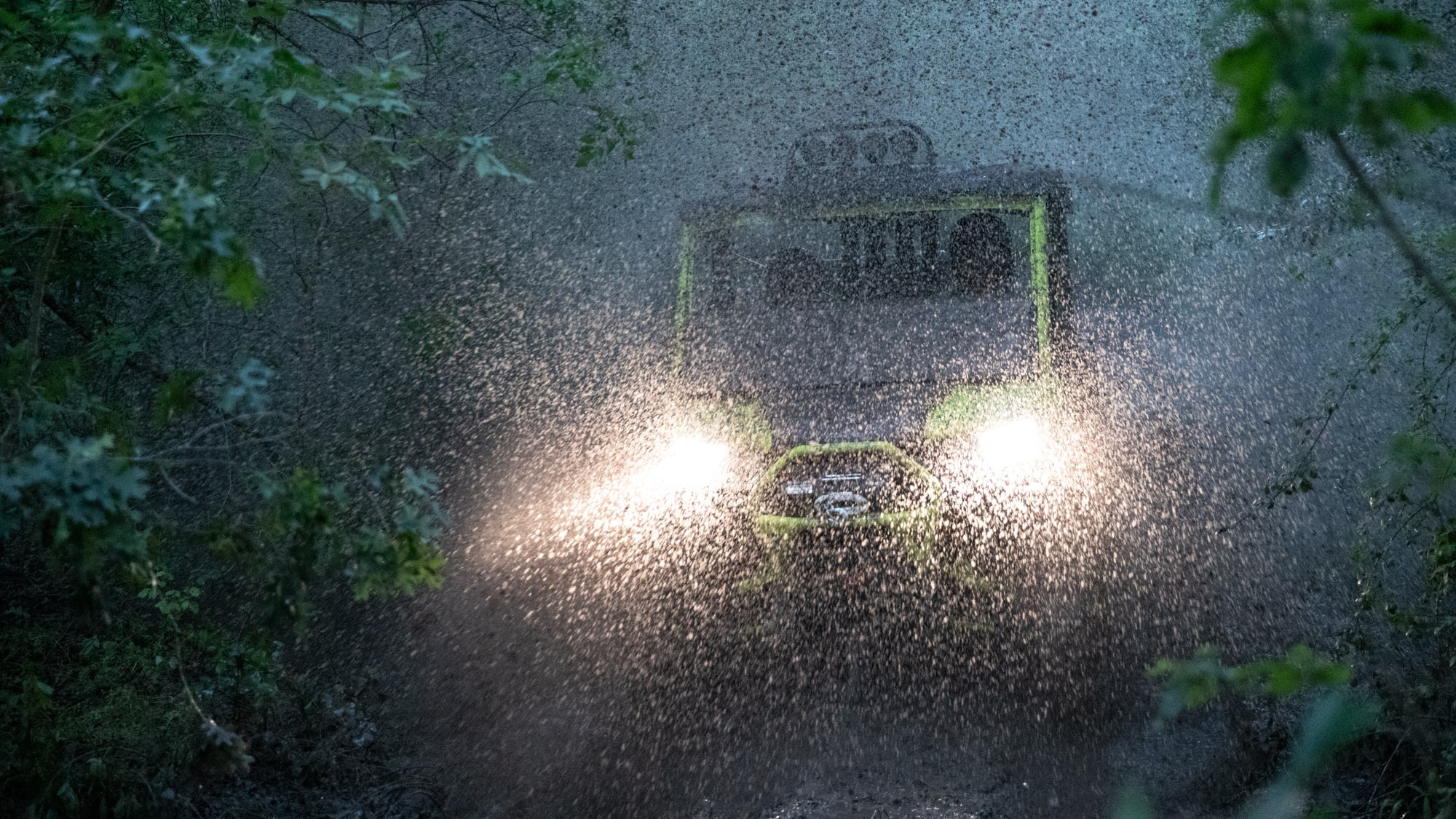 Men driving Traxter through heavy rain