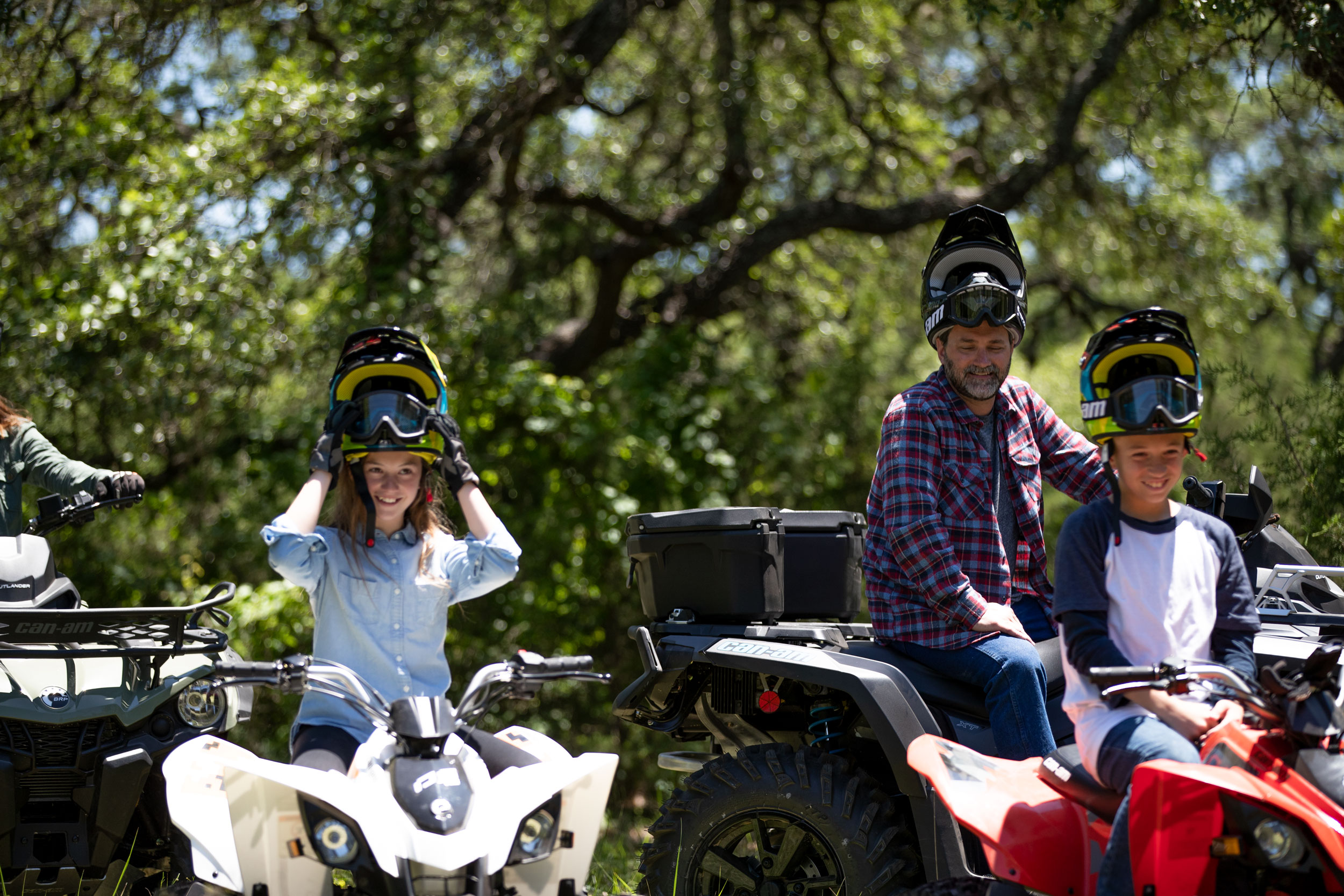 Family near their DS and Outlander ATV in the woodland