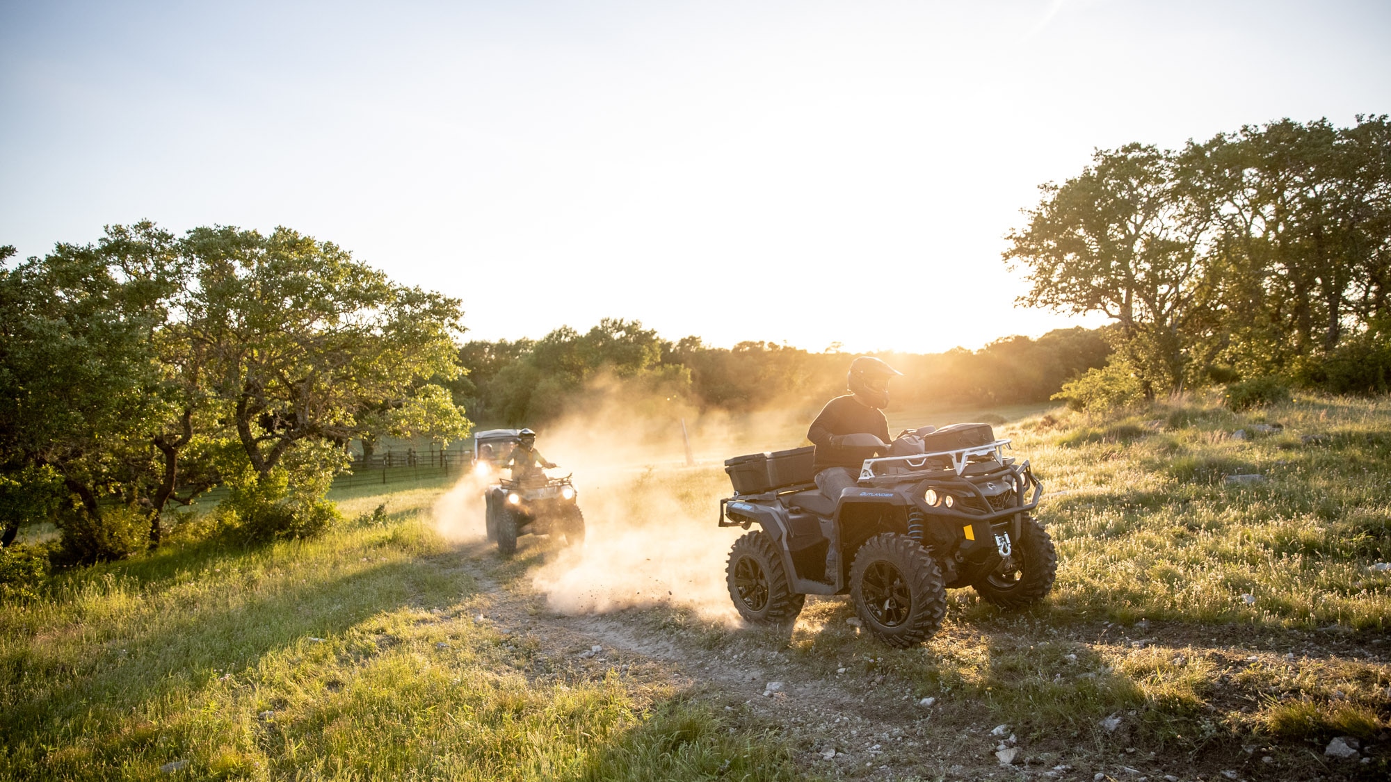 Pair of Can-Am Outlander 2021 driving in a scenic trail