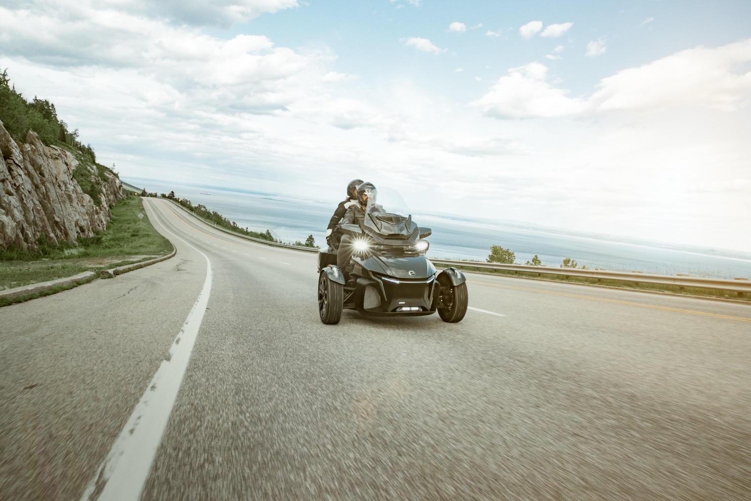A couple driving a Can-Am Spyder RT on a scenic road