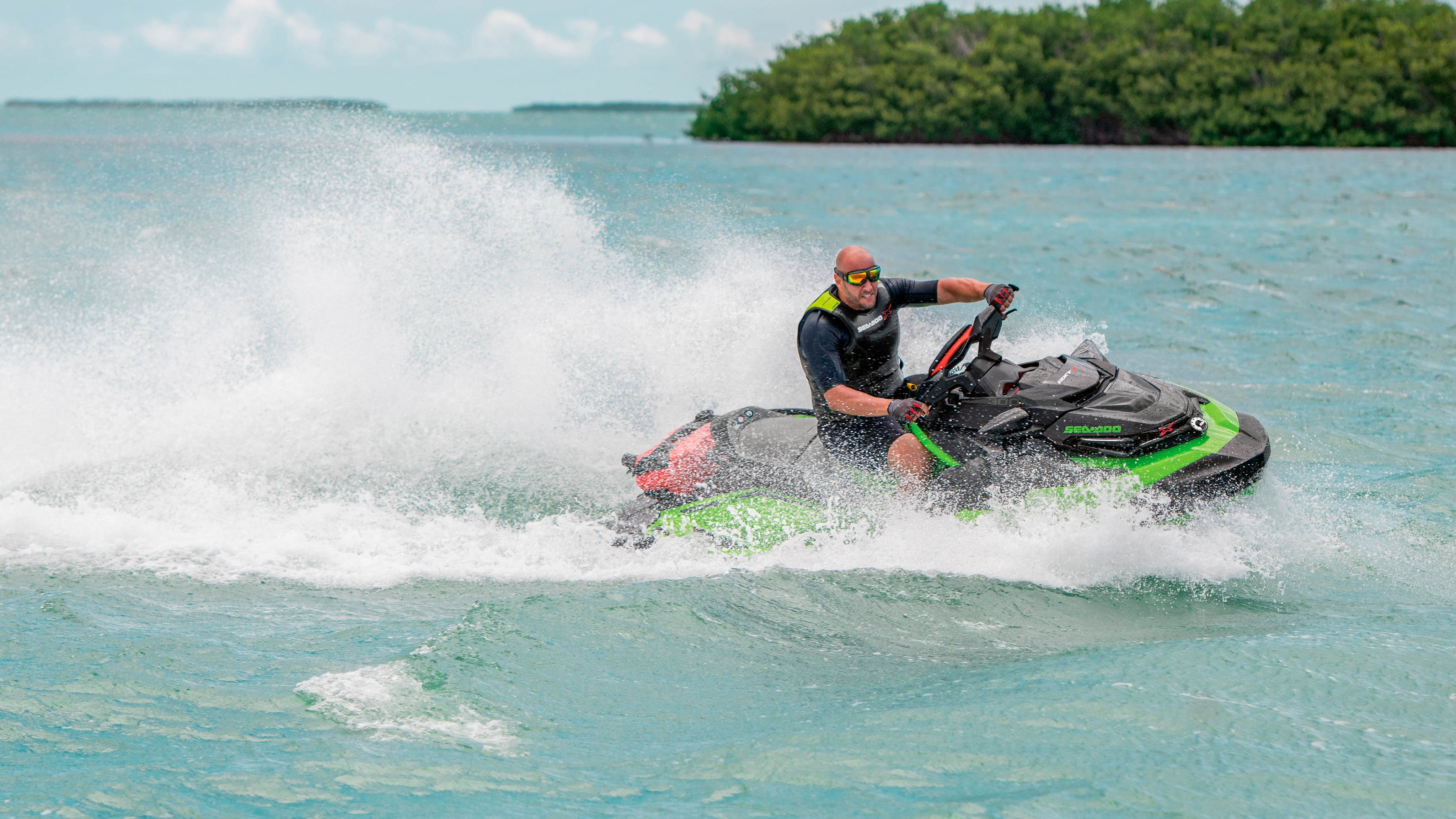 Man riding his Sea-Doo RXT-X next to a patch of land