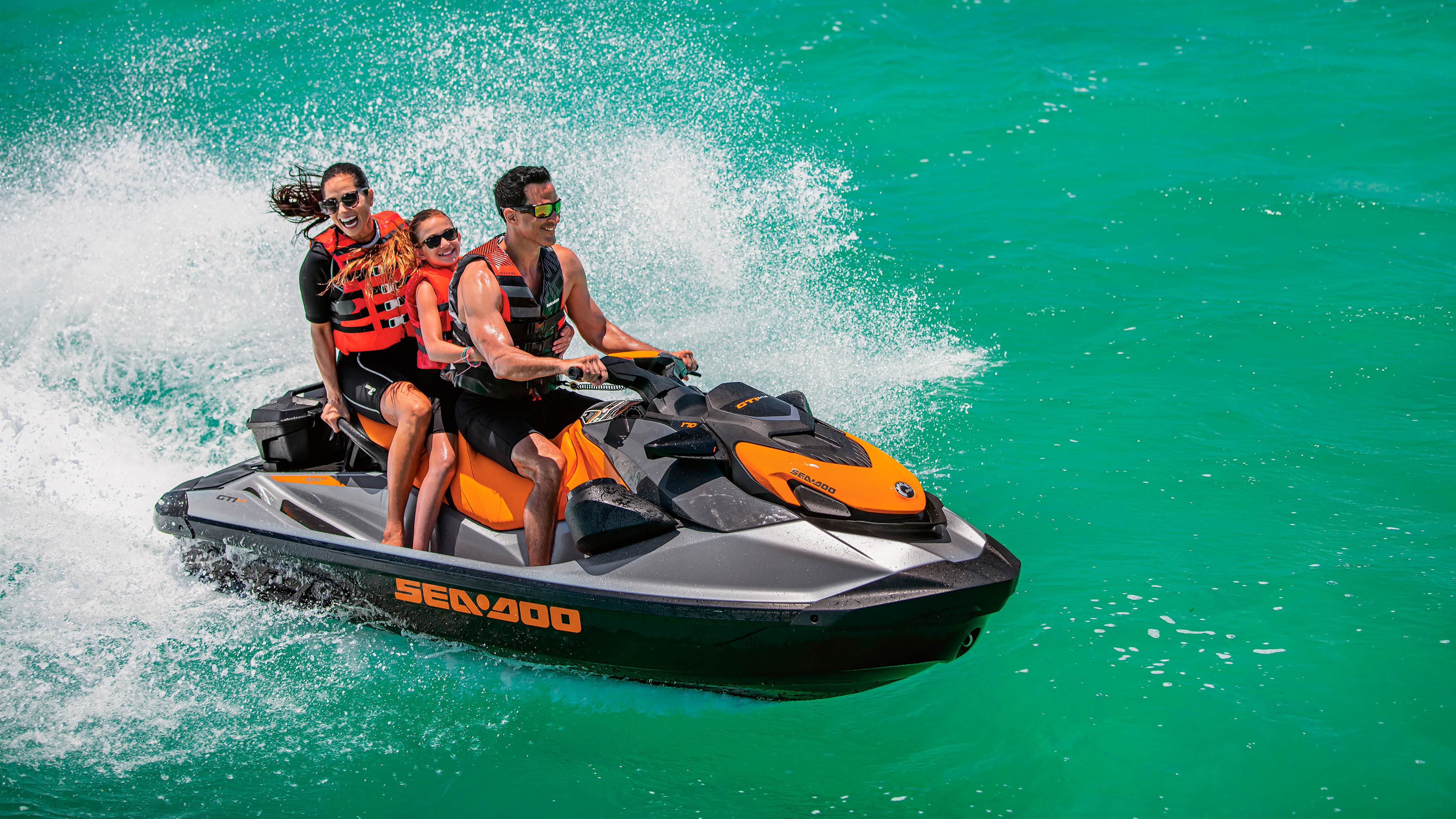 Three people riding a Sea-Doo GTI SE in the water