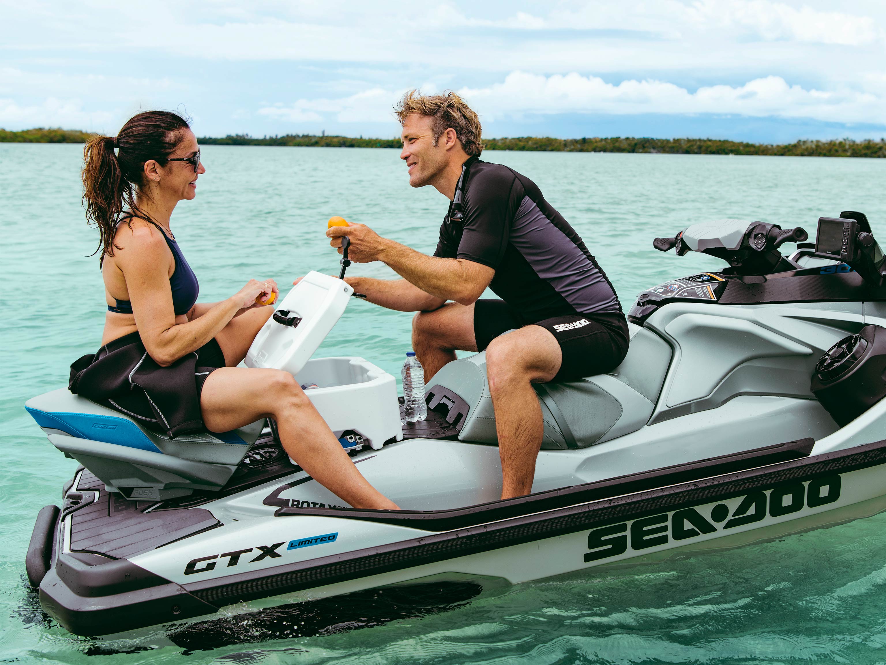 Man and Woman discussing on the back of a Sea-Doo GTX LTD