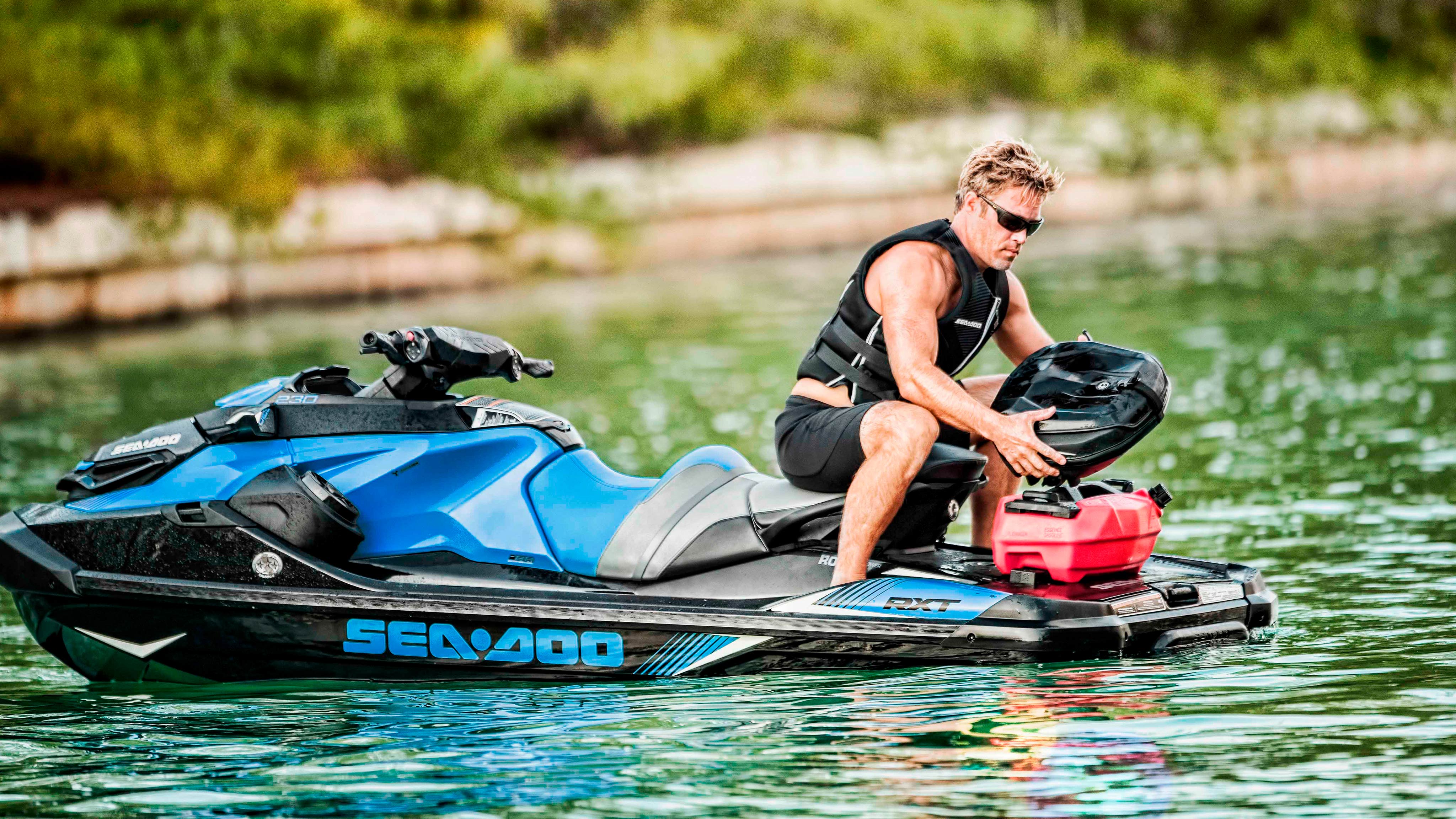 Man holding a Sea-Doo accessory on the back of his GTX