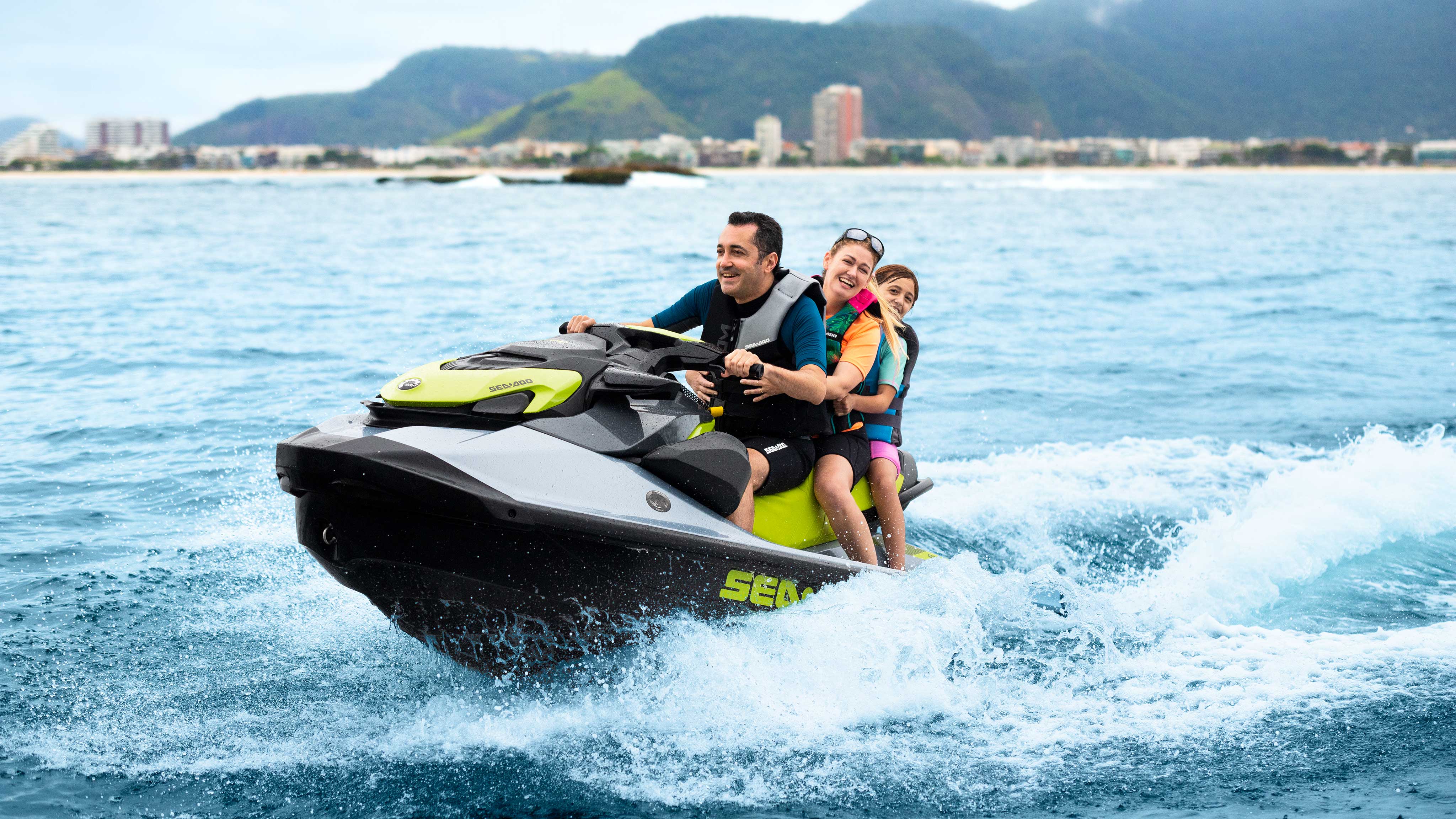 A man and a woman riding a Sea-Doo GTI