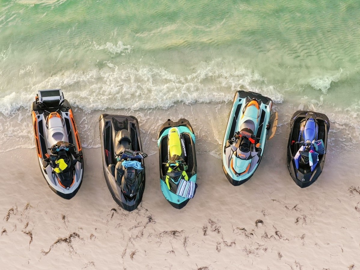 Multiple Sea-Doo watercraft on a beach