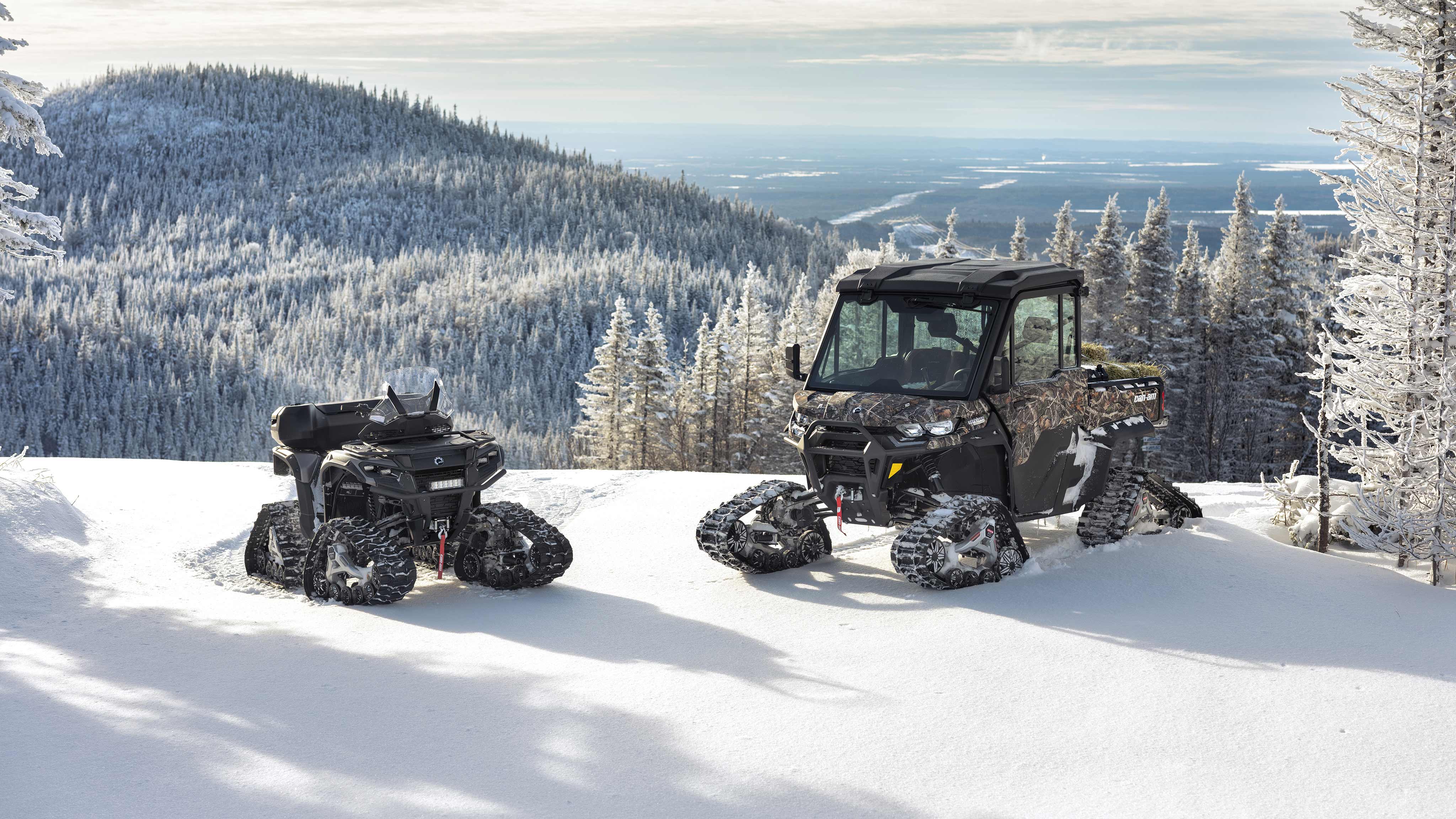 Outlander and Traxter on top of a snowy mountain