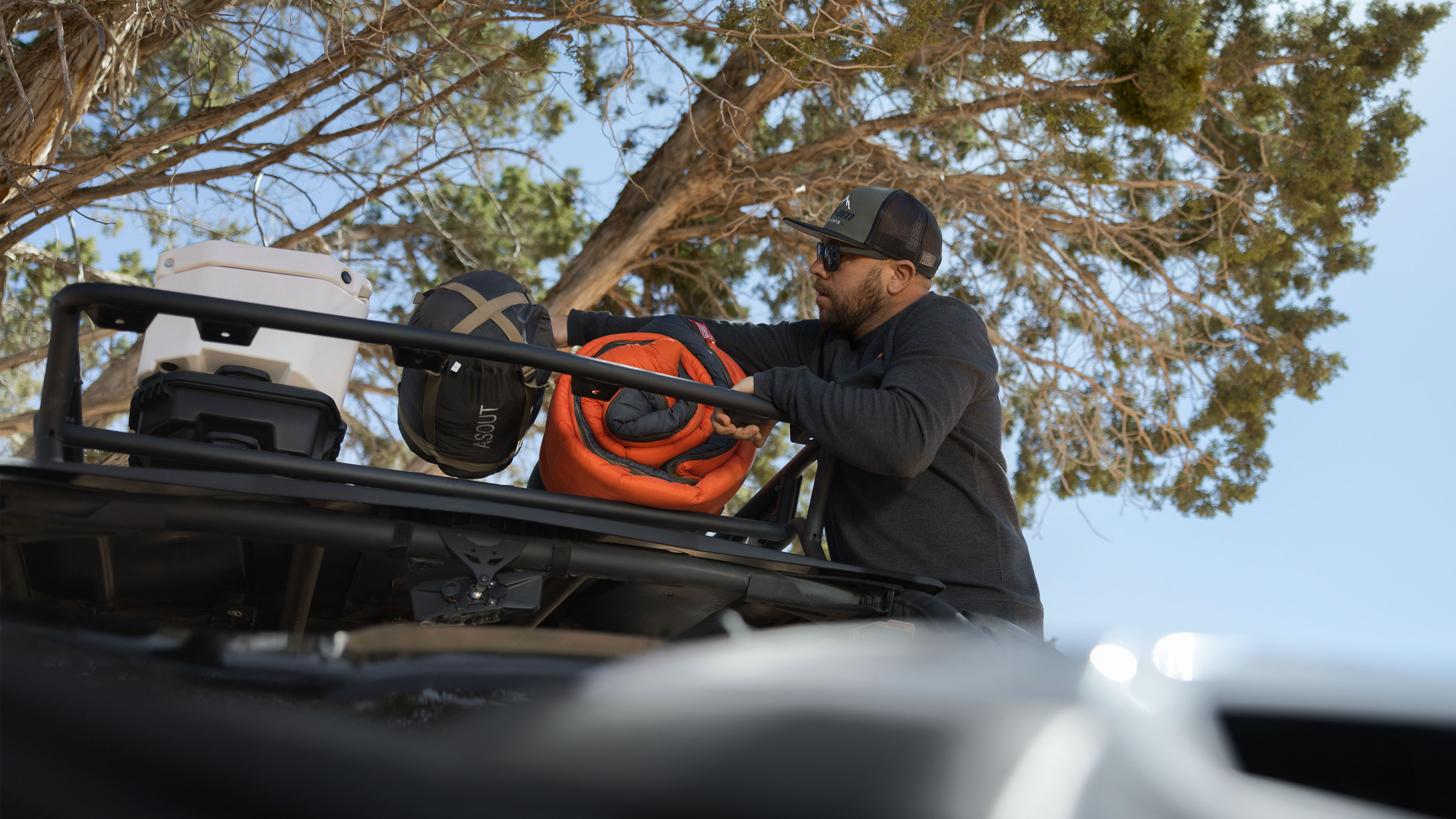 Man loads gear on Can-Am vehicle