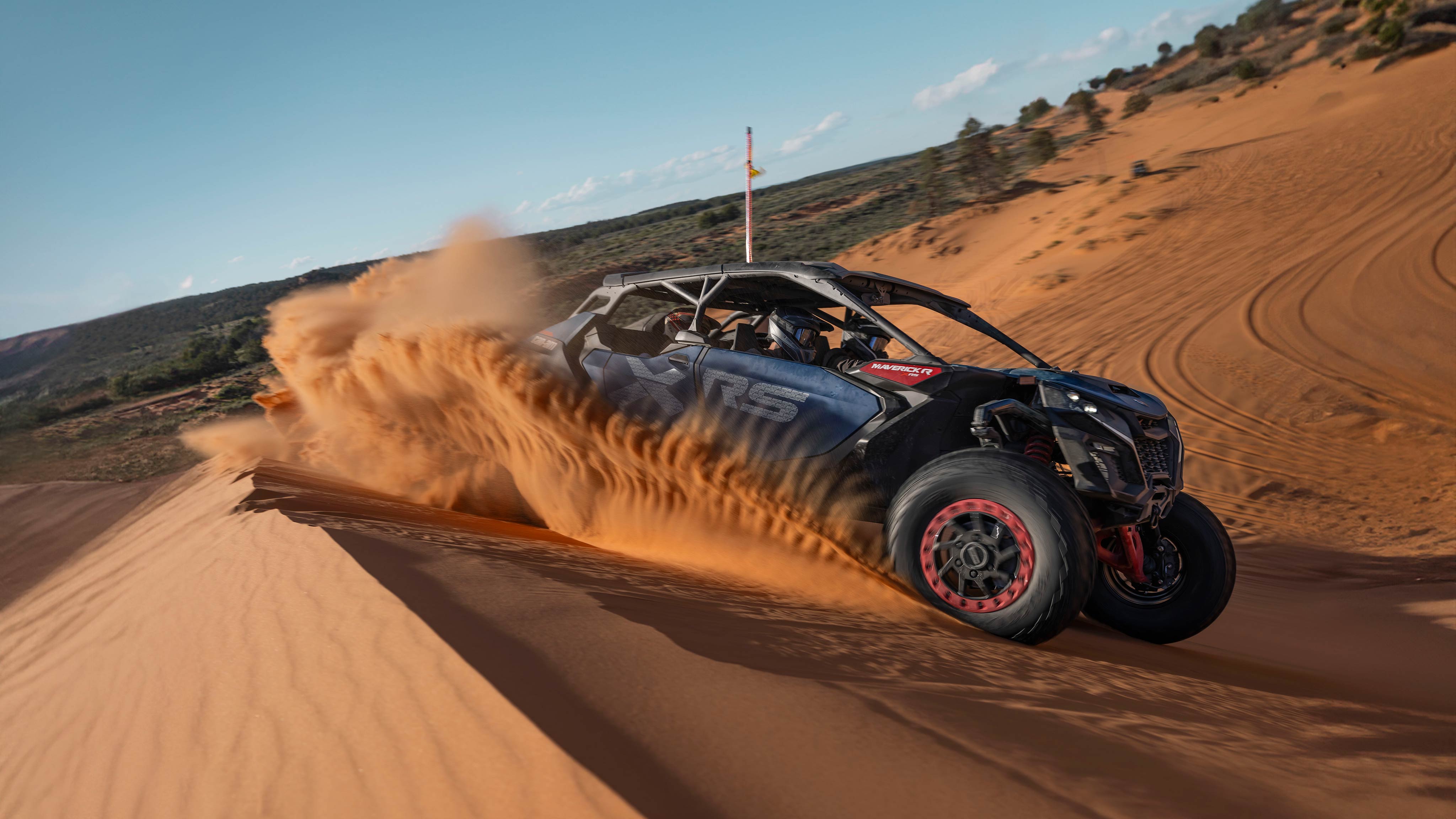 Can-am Maverick R Max X RS speeding through the sand dunes