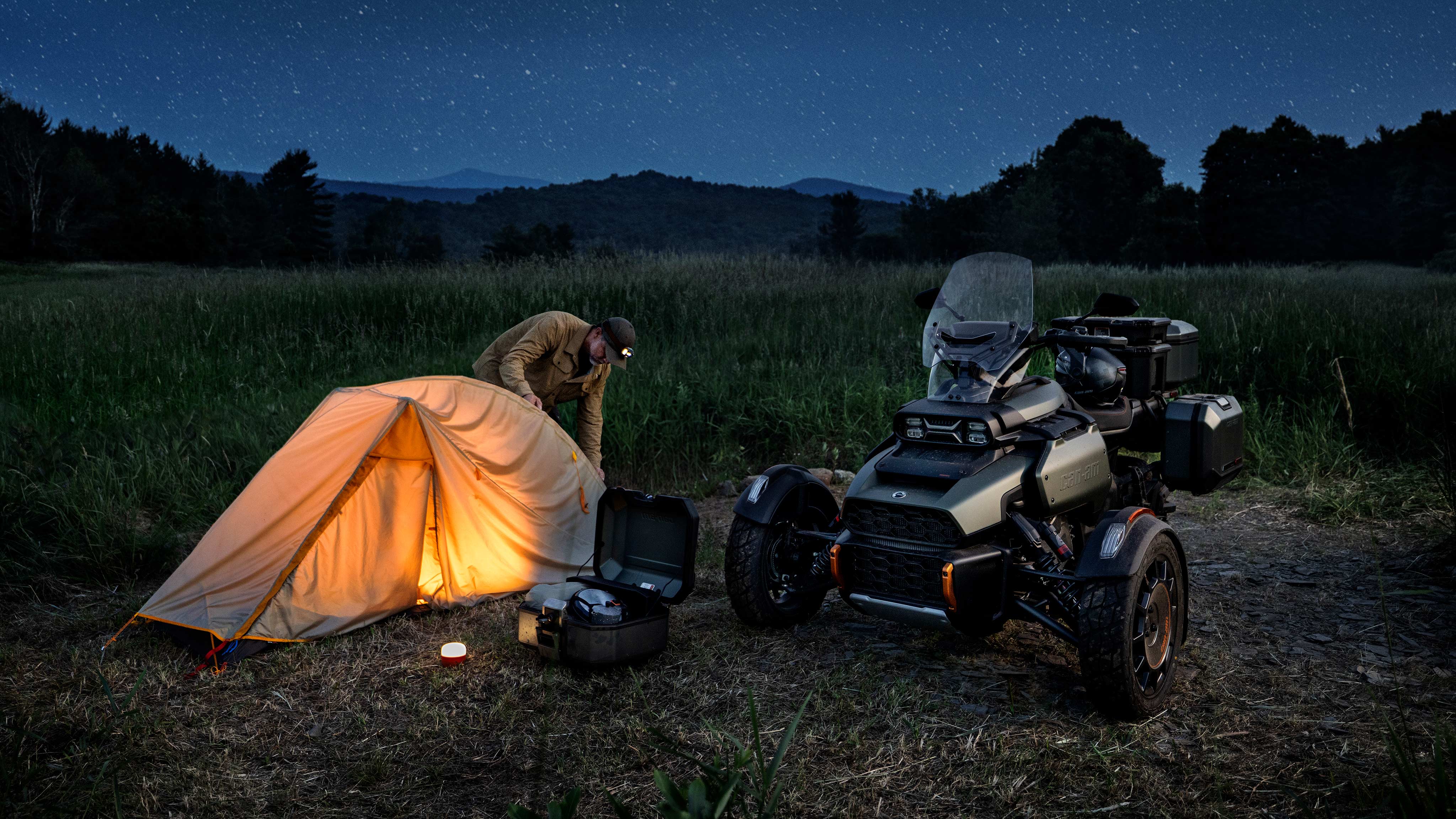 Man setting up a tent next to the new Can-Am Canyon