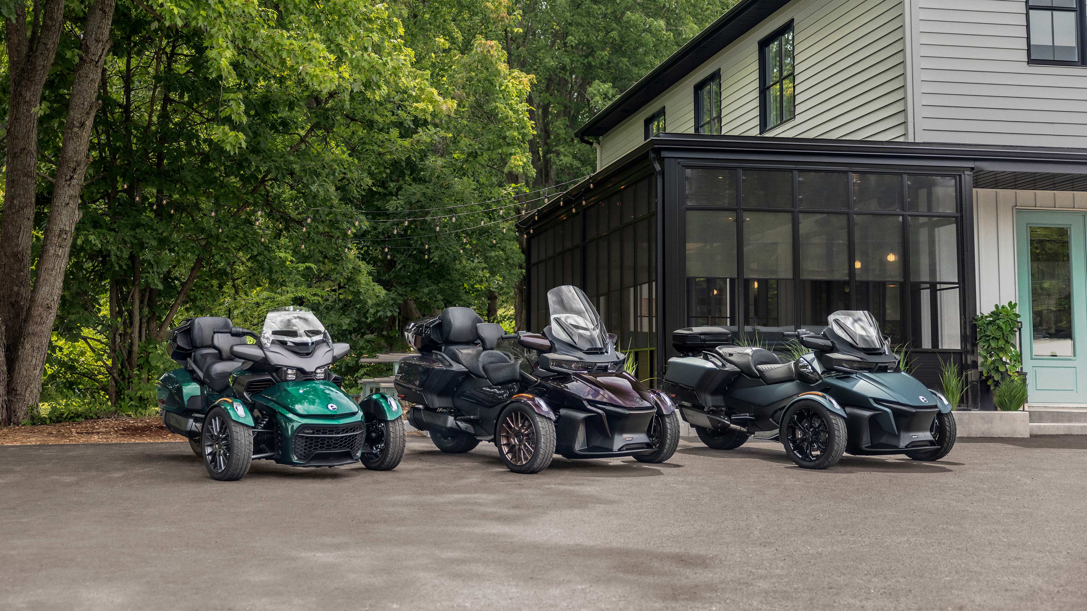 The Can-Am On-Road Family: Three 3-wheel vehicules parked next to each other 