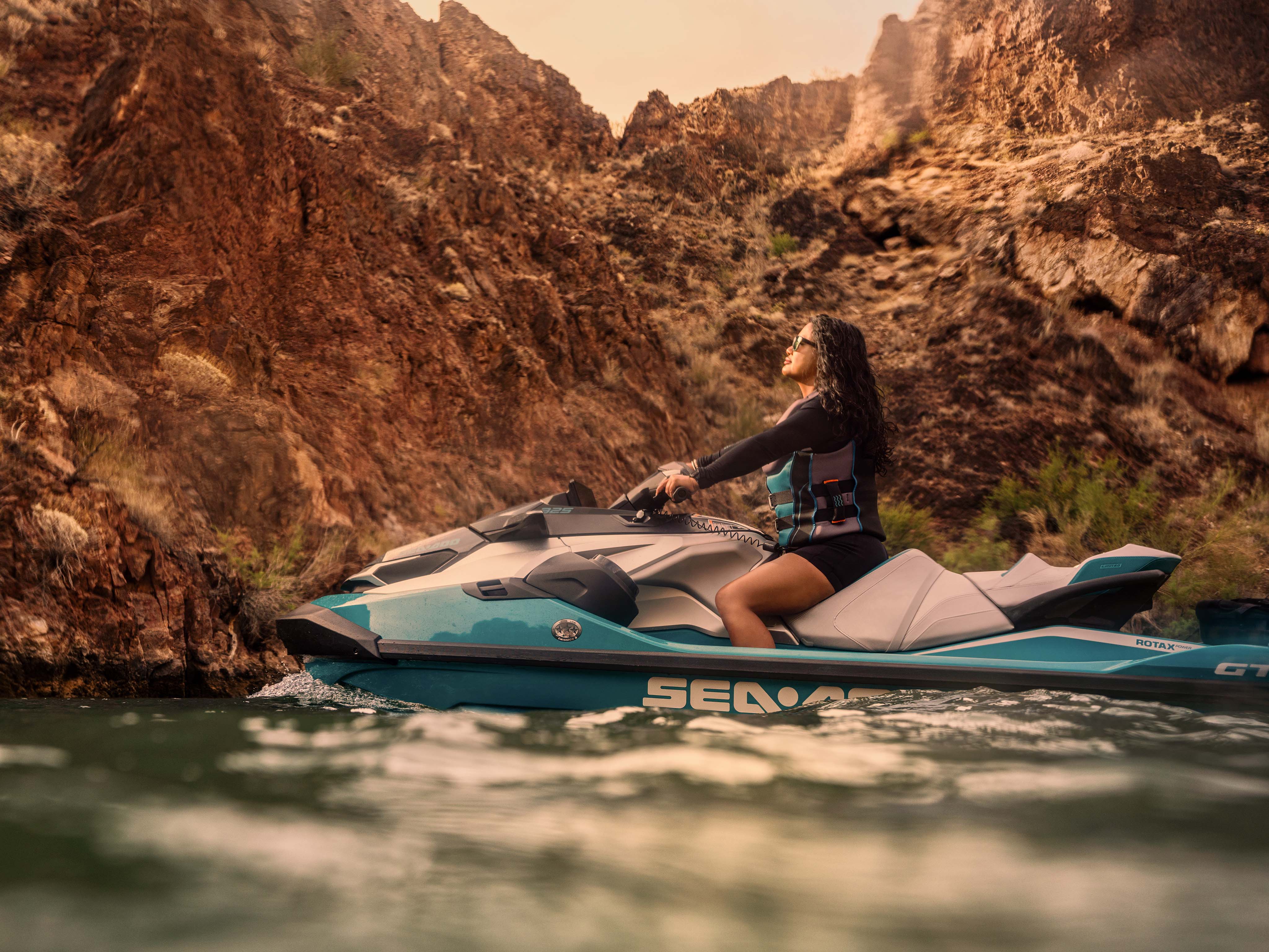 Man and woman sitting on a Sea-Doo GTX Limited personal watercraft