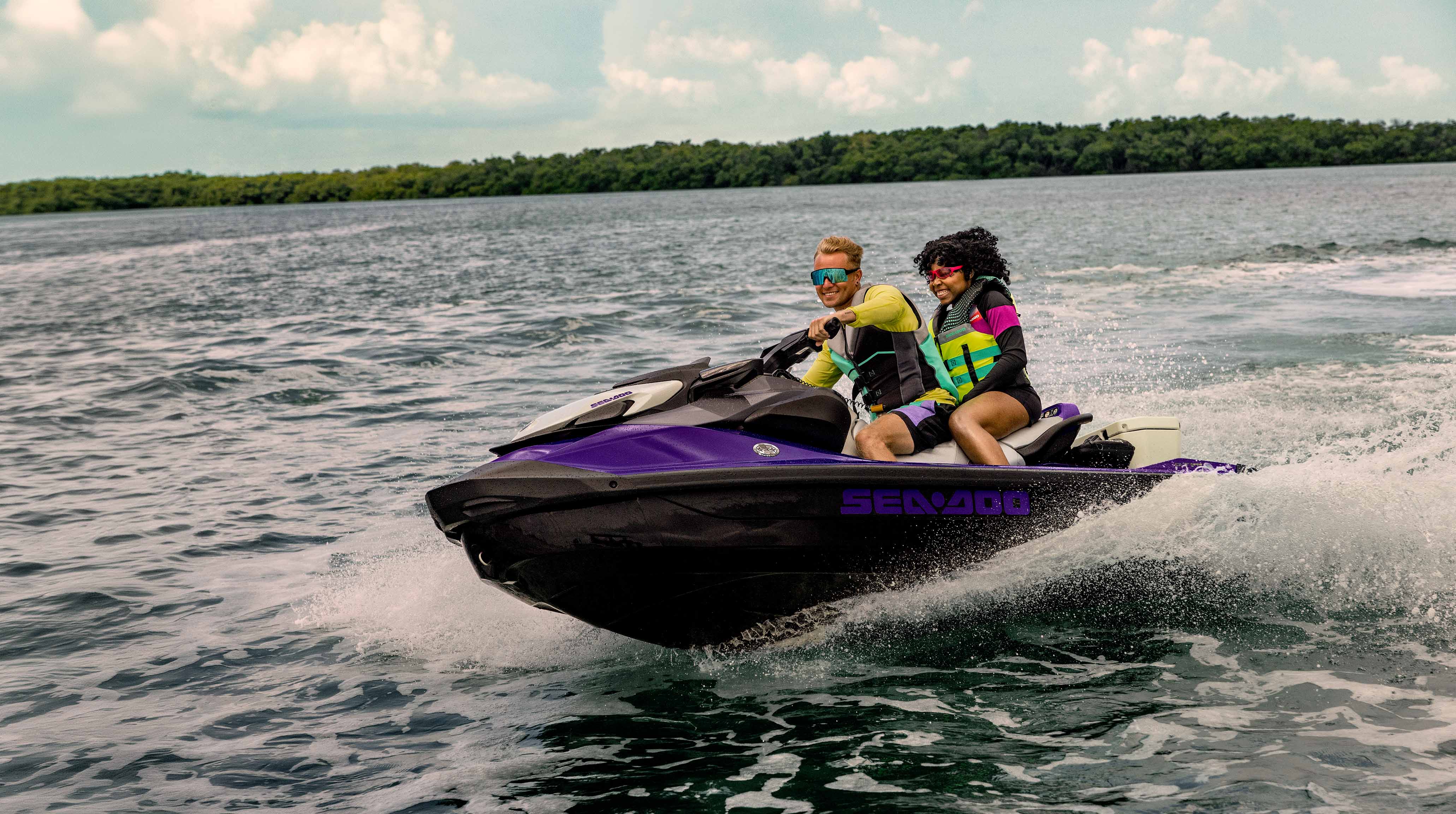 Two women talking on an idle recreational Sea-Doo GTI