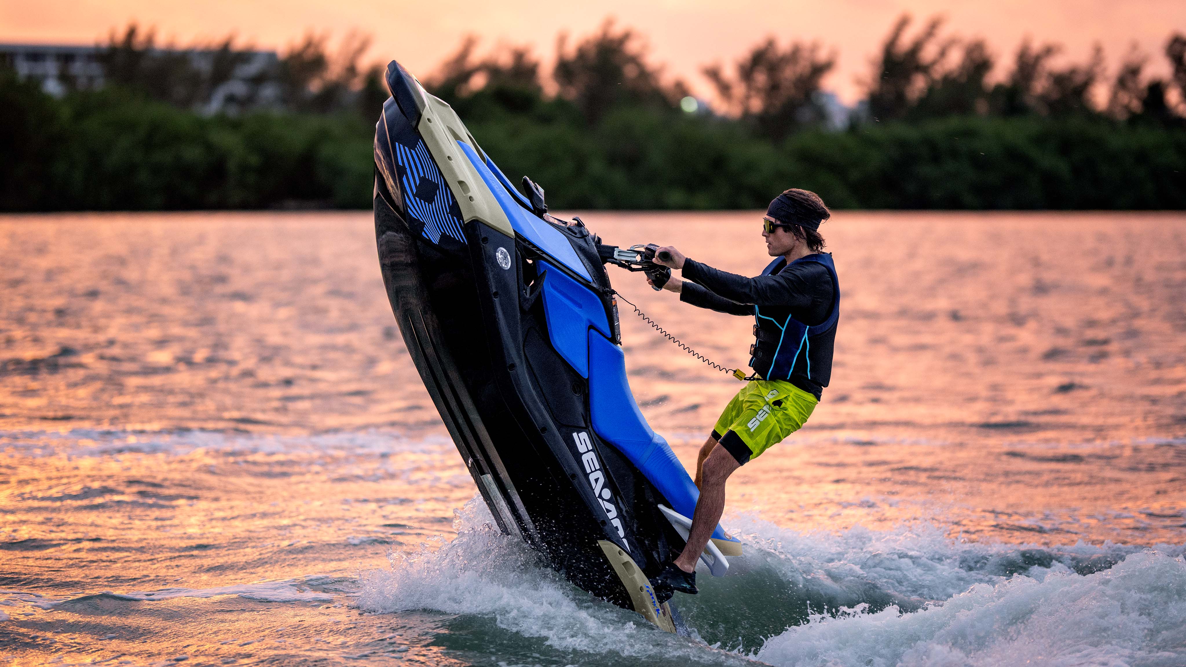 Couple riding a Sea-Doo Spark Trixx personal watercraft