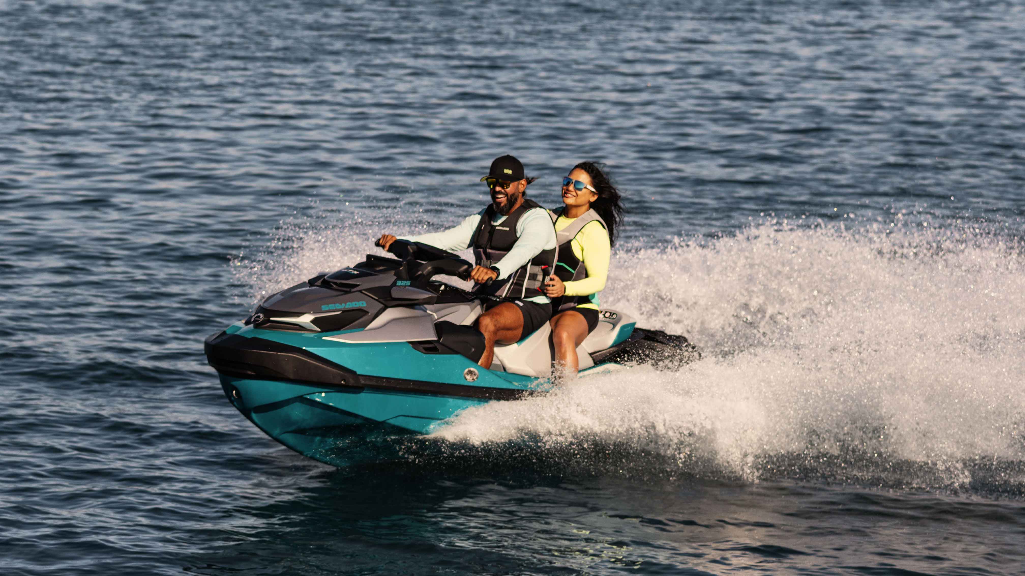 Man and woman sitting on a Sea-Doo GTX Limited personal watercraft