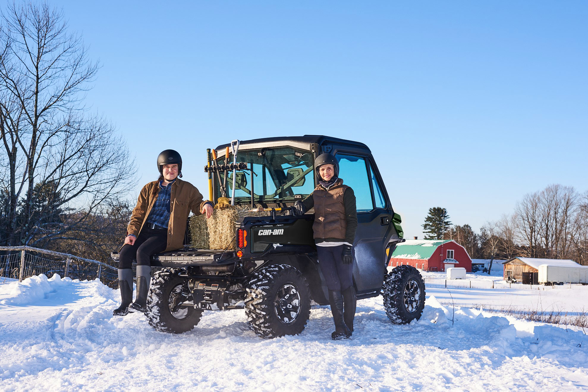 A man and woman next to Can-Am Traxter