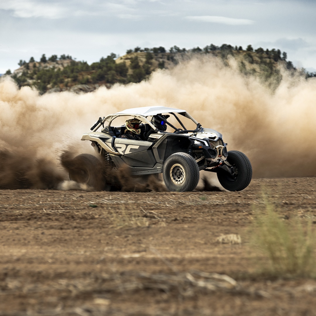 Man driving a Can-Am Maverick in the sand