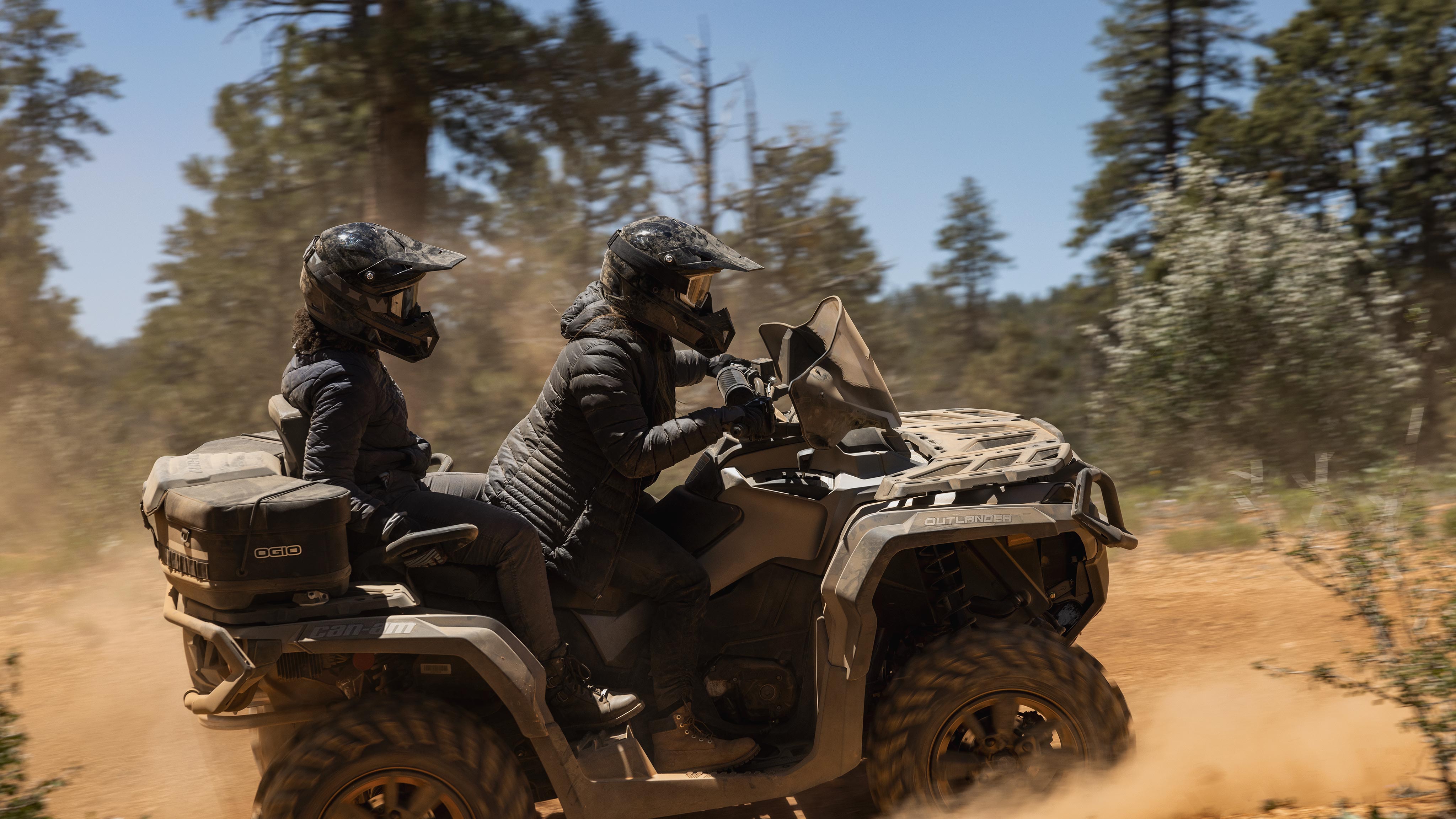 Two riders riding a 2-seater Can-Am Outlander MAX