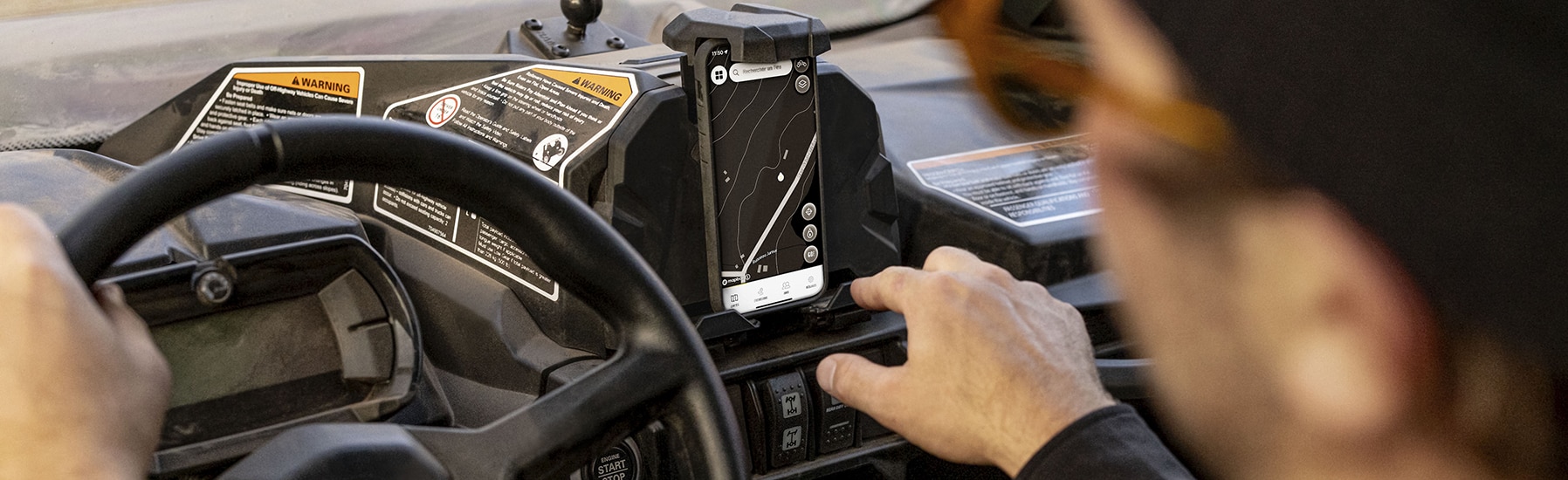 Rider using the BRP GO! on a mobile phone set on a phone holder