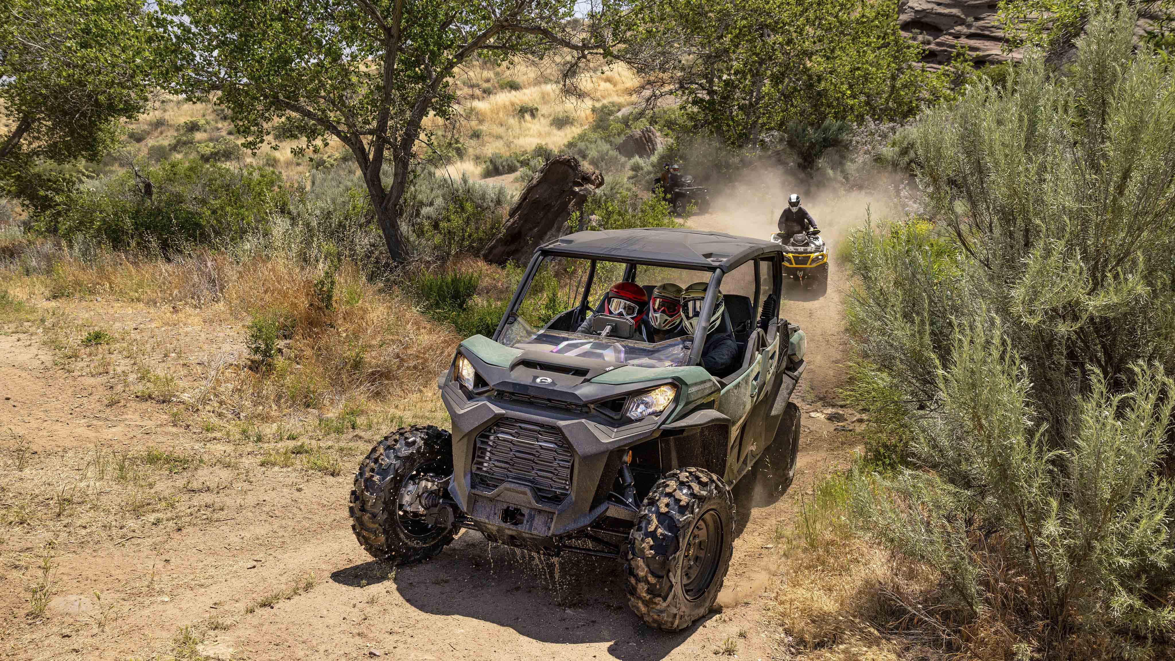 Can-Am SxS and VTT riding in a field