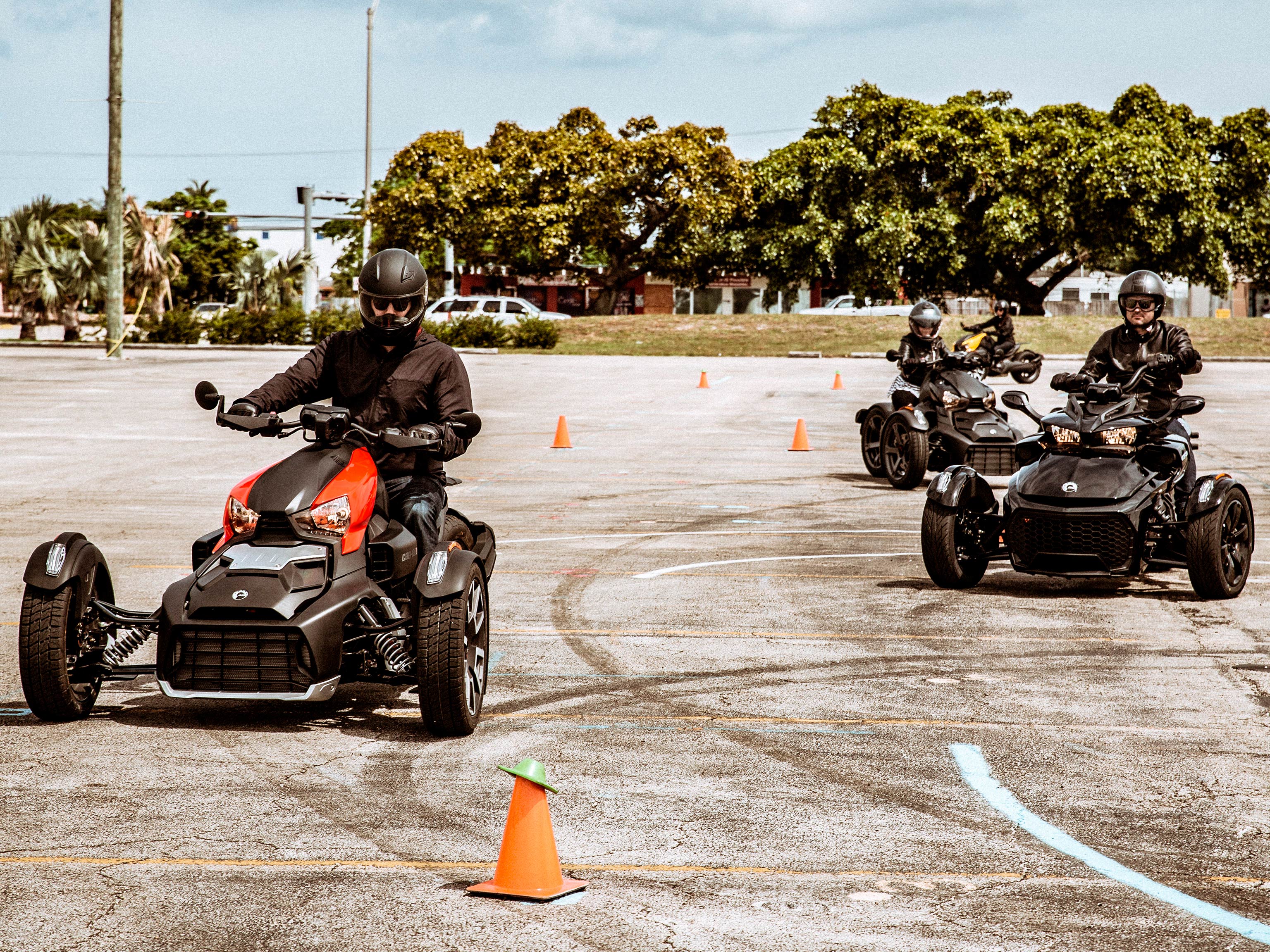 Can-Am Ryker and Spyder vehicles on a learning circuit with orange cones