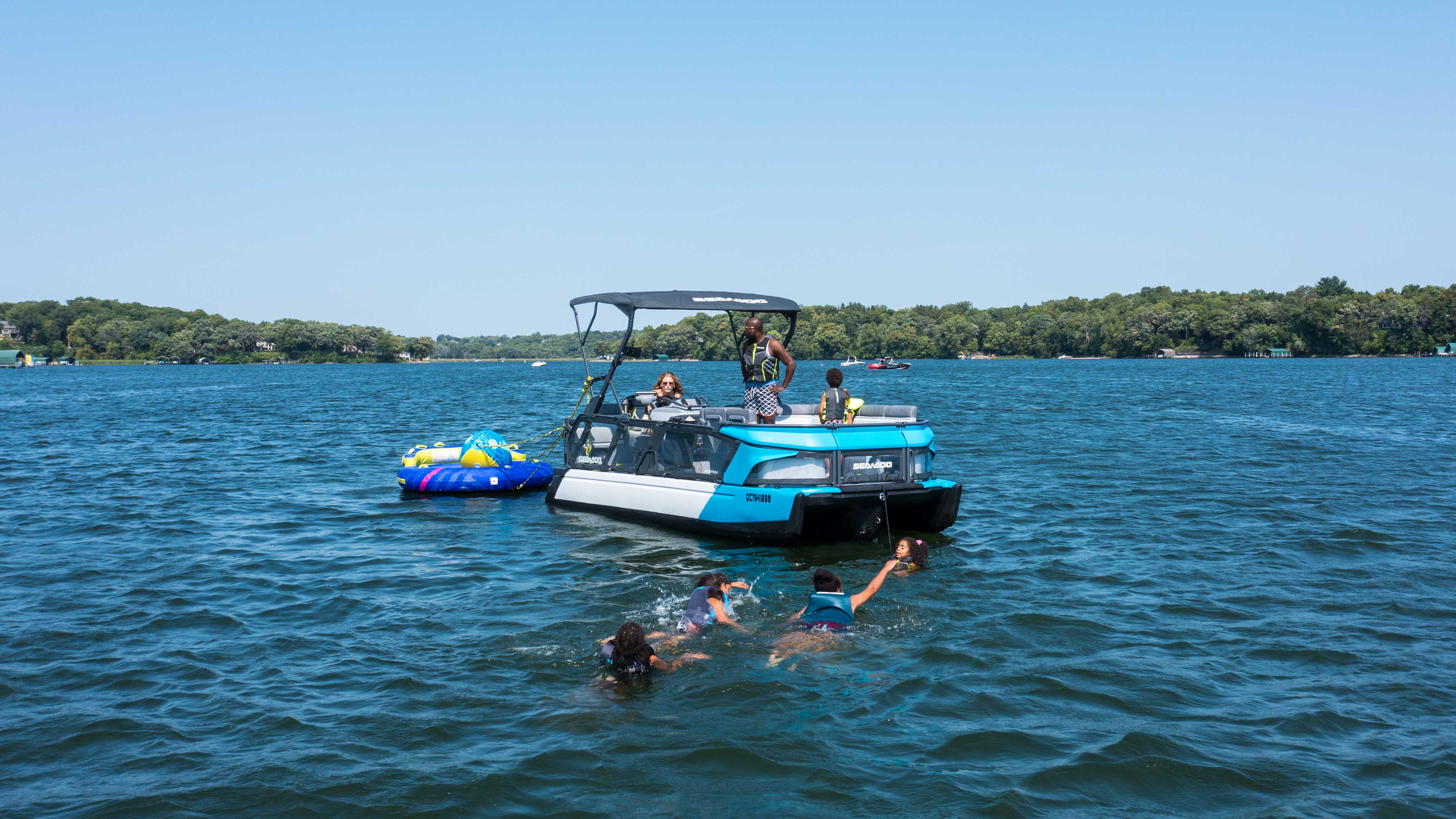 Family swimming next to Sea-Doo SWITCH